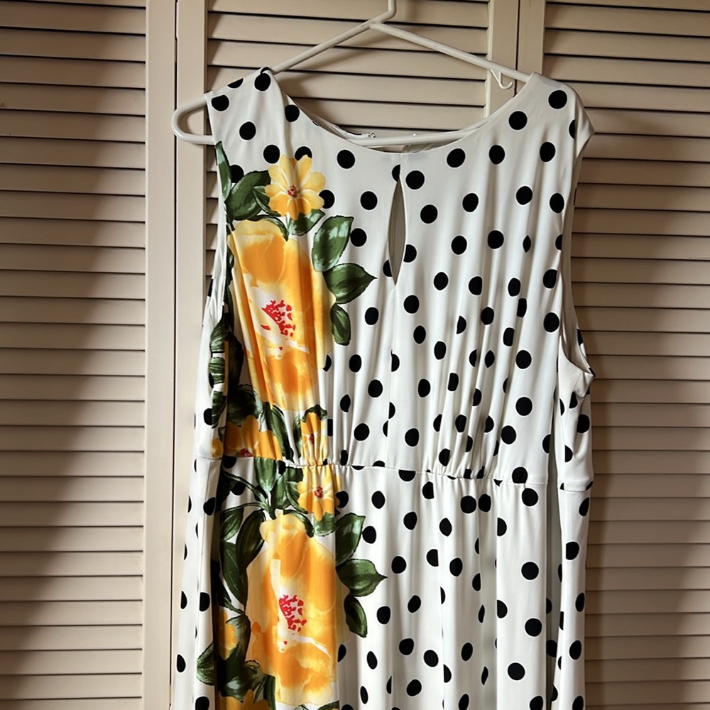 Black and white polka dot dress with yellow flowers. Keyhole opening at front.